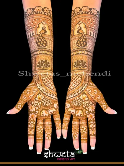 This full-hand design combines graceful peacocks on the forearm with rows of elephants on the palm, creating a beautiful and traditional bridal look.