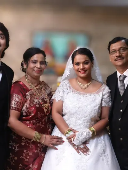 A lovely family photo from the wedding day. The bride's classic look, with her hair pulled back and soft makeup, is perfect for these formal portraits.