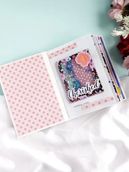 A "Cherished" shaker window adds a touch of sparkle to this mini scrapbook.