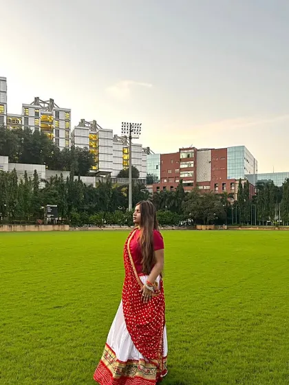 The simplicity of this white and red ghagra is what makes it so elegant. It looks stunning against the green grass.