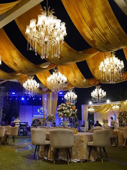 Another perspective of the guest seating, highlighting the elegant round tables and the immersive experience created by the overhead decor.