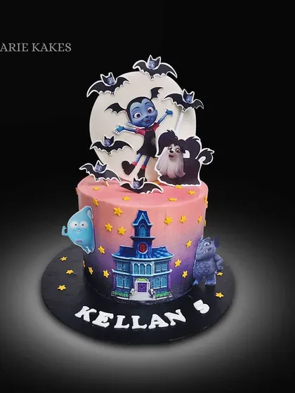 A spooky-fun Vampirina cake for Kellan's 5th birthday. This cake features a sunset-hued buttercream finish and is decorated with edible images of the characters against a full moon.