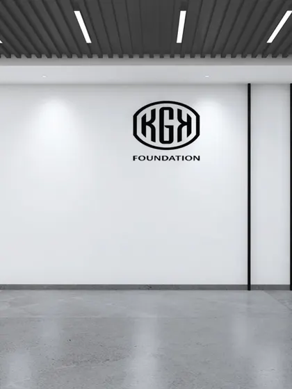 Another view of the KGK Foundation foyer, this time featuring the organization's logo. The design is intentionally stark and powerful, using negative space and focused lighting to draw attention to the brand identity.