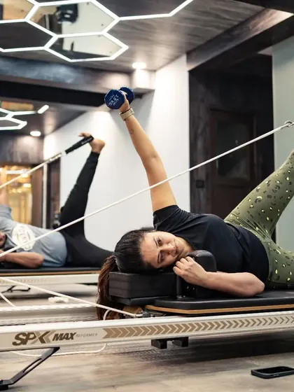 This client is performing a side-lying leg press with dumbbell, an exercise that strengthens the glutes and obliques while challenging core stability.