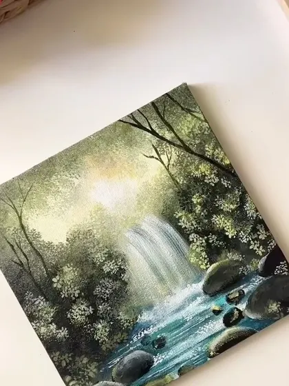 A finished acrylic painting of a sunlit waterfall. I love how the light hits the water and illuminates the surrounding green leaves.