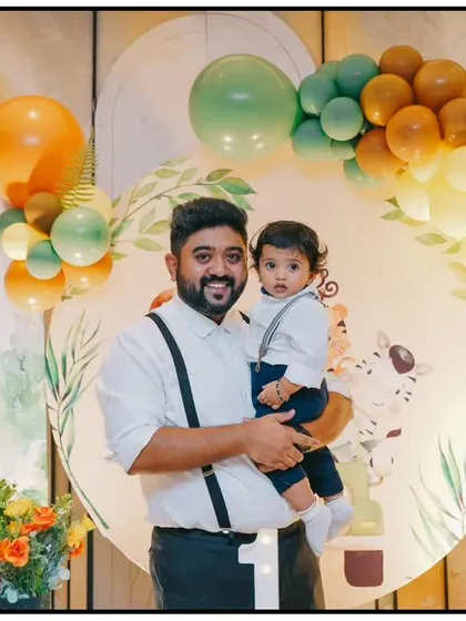 A candid shot of a father and son at a jungle-themed first birthday. My goal is to create a joyful environment where families can relax and celebrate these precious milestones.