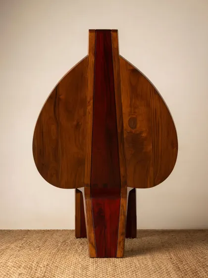 Various angles of the Vismayam chair, showcasing its intricate details, the contrast of different wood grains, and its powerful, sculptural presence. Each view offers a new perspective on this piece of collectible, art-inspired furniture.