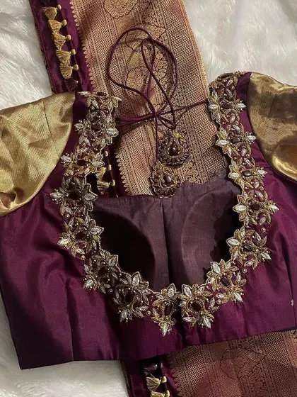 A client's order for a wine-colored bridal blouse with a stunning, heavily embroidered floral back design.