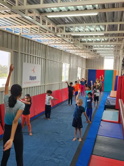 A group of young gymnasts learning together during a warm-up session. I lead them through each movement to ensure proper form and get them ready for the day.