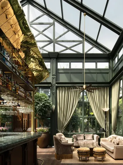 The soaring glass ceiling of the Lord Elgin Glasshouse in Amritsar. This structure is the defining feature, creating a dramatic, light-filled volume that connects the opulent interior with the sky.