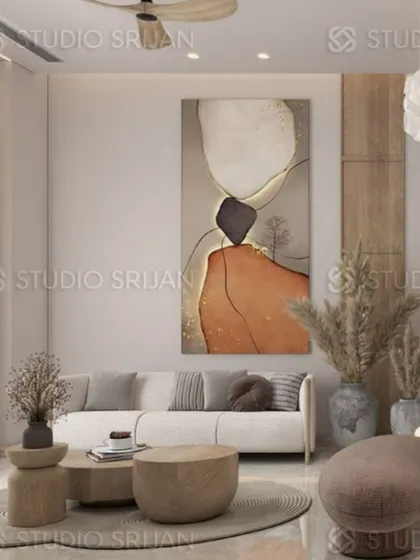 This seating area in Greenwood City is defined by its earthy tones, natural textures like pampas grass, and a large abstract art piece.
