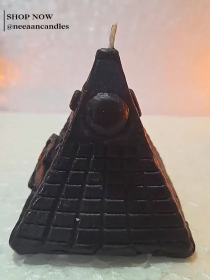 This is my Eye of Horus candle, shaped like a pyramid. I designed it to be a powerful symbol of protection, wisdom, and spiritual awakening for your altar or sacred space.
