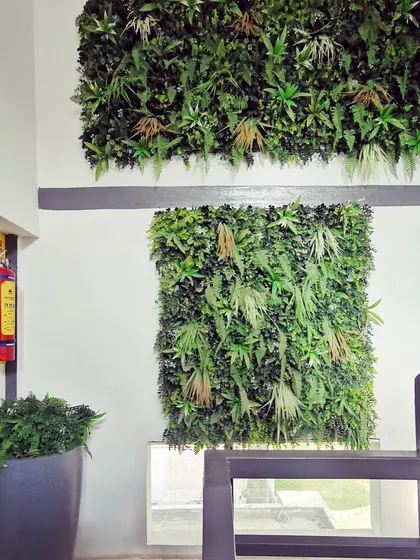 A vertical garden or green wall installed in the stairwell. This biophilic design element improves air quality and adds a touch of nature and visual interest to a transitional space.