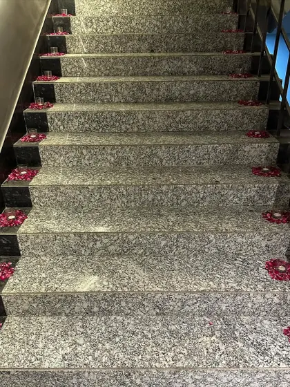 Simple elegance for Diwali. We decorated this staircase with small candles placed inside circles of fresh flower petals, creating a beautiful and fragrant pathway.