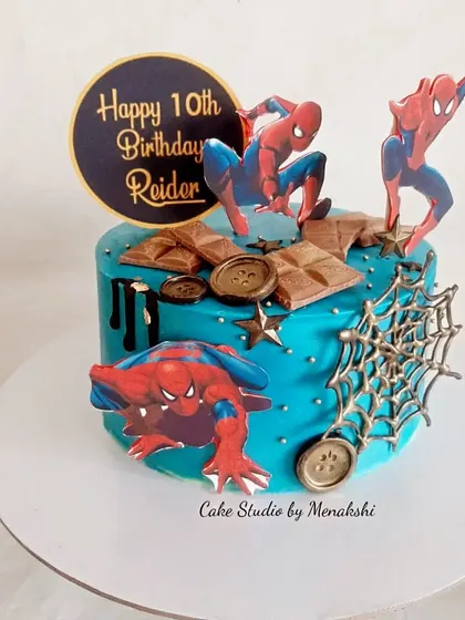 A stunning Spider-Man themed cake made with zero fondant. The vibrant blue buttercream is the perfect backdrop for the web-slinger and his web.