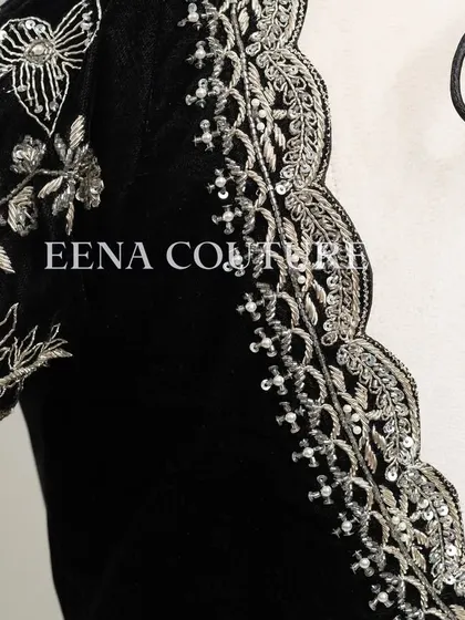 For a chic and contemporary look, I designed this black velvet blouse. It features intricate silver floral embroidery along the scalloped neckline and sleeves, creating a stunning contrast that is perfect for any special occasion.