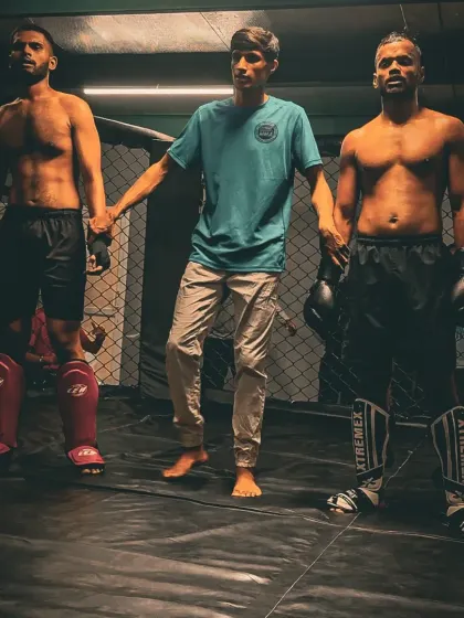 The calm before the storm. Two of our fighters face off with their coach before their match at our in-house kickboxing tournament. These events build experience and team spirit.