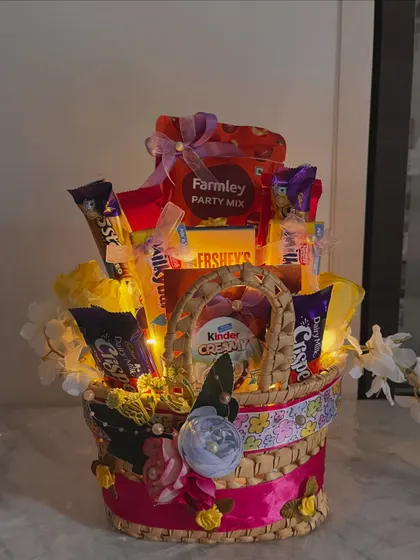 The final, picture perfect shot of the yellow chocolate and snack basket, ready to make someone's birthday a whole lot sweeter.