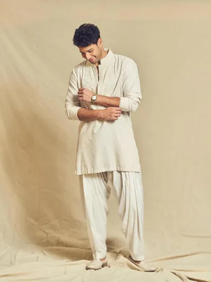 A candid moment showing Siddhant's relaxed Eid look. The Pathani salwar adds a traditional touch to the contemporary embroidered kurta.