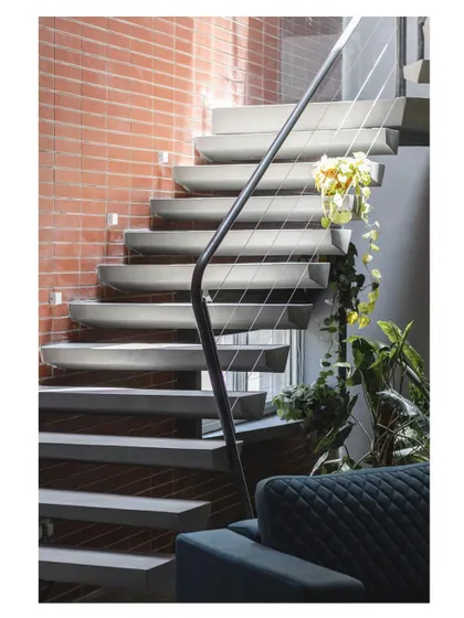 We believe details define the design. This floating staircase, carved from concrete, is a study in minimalism and structural engineering. Each step is a wedge-like form, creating a sense of lightness and motion that transforms a functional element into a sculptural centerpiece.