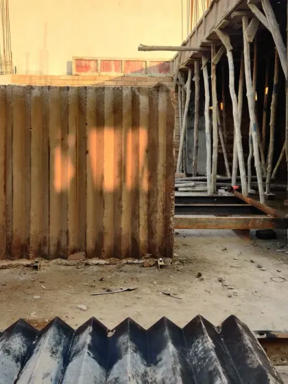 The formwork for a poured earth wall, with the evening sun casting a warm glow.