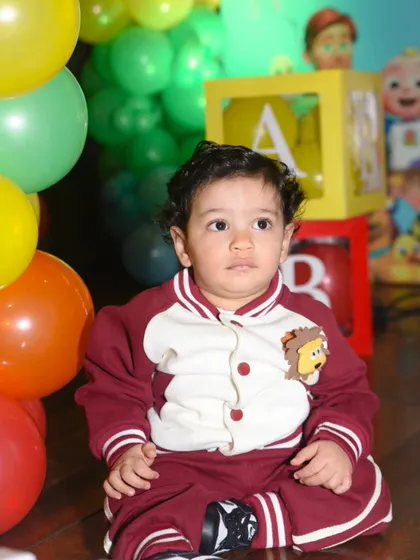 A quiet moment amidst the party fun. A sweet, candid portrait of the one-year-old birthday boy.