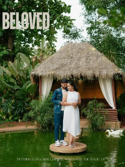 A romantic portrait at a beautiful resort. The couple stands on a small island in a pond, surrounded by lush greenery and swans, creating a fairytale-like setting for their pre-wedding shoot.