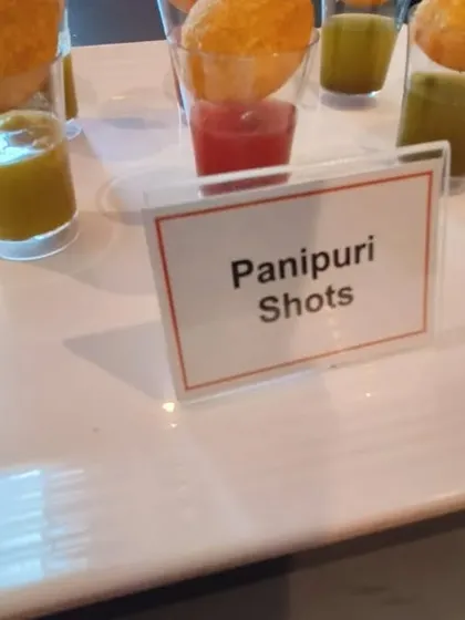 A close-up of our innovative Panipuri Shots, a modern and mess-free way to enjoy a classic. Each shot glass contains flavored water, making it easy for guests to grab and go.