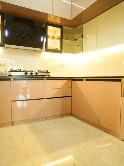 This image shows the reflection on the high-gloss pink and white cabinets, a testament to the quality of our factory finishes. The clean lines and soft colors create a sophisticated and inviting kitchen.