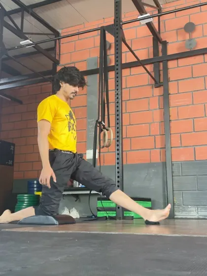 An earlier photo from my splits journey, showing the beginning stages of the movement. Every advanced skill starts with foundational work like this.