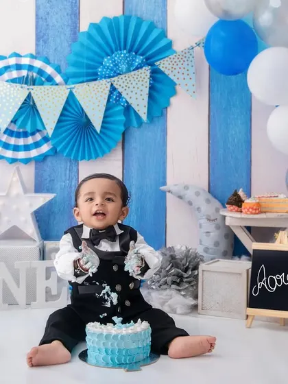 The moment of truth. This little boy dives right into his first birthday cake, a perfect capture of his curious and playful nature.