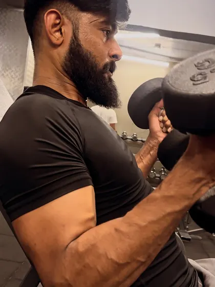 A dumbbell bicep curl, focusing on the squeeze at the top to build a strong peak.