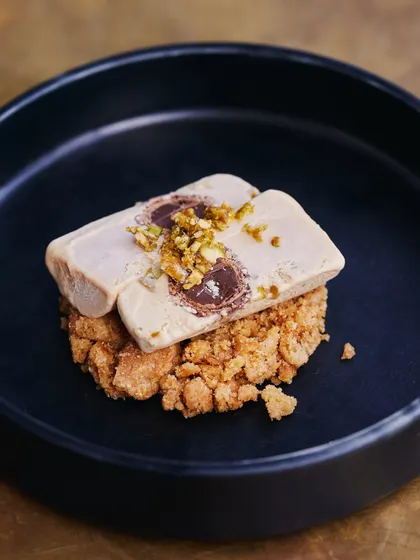 A beautifully plated Salted Chikki Kulfi, a dessert that is both playful and sophisticated.