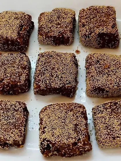 Our finished energy bars, coated with poppy seeds and cut into squares. They are a delicious, healthy, and power-packed snack made entirely by the children.