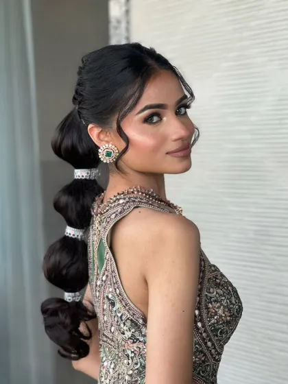 The complete look from the side, showcasing the stunning bubble ponytail that adds a modern twist to this festive outfit.
