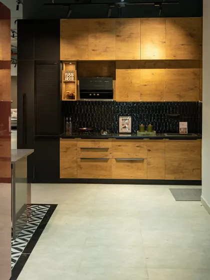 A rustic-modern kitchen design with natural wood-finish cabinets and a striking dark blue tile backsplash. This shows how to blend earthy textures with a contemporary layout.