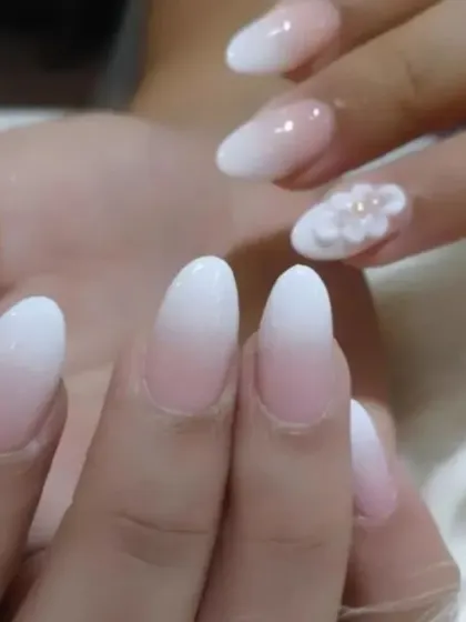 A beautiful example of combining ombre with 3D art. This set features a classic baby boomer base with a delicate, sculpted white flower on the ring finger.