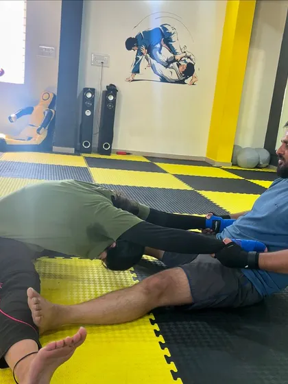 Another example of assisted stretching, where a training partner helps to deepen a stretch for better results and injury prevention.