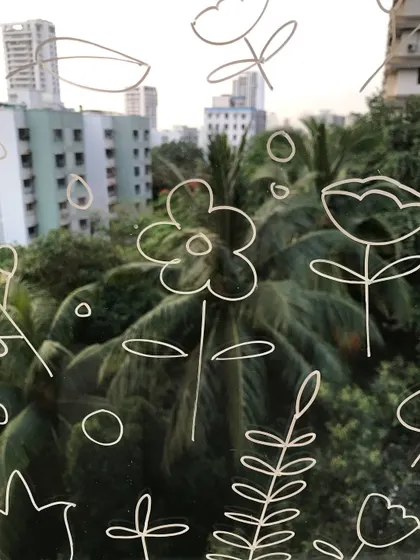 I love adding personal touches to my studio, like these little floral doodles I drew on the window. They add a bit of character to the space.