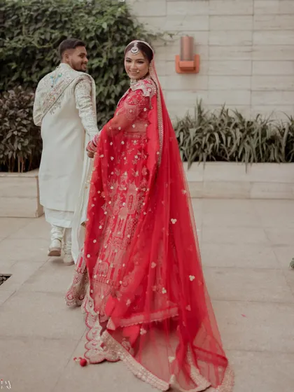 A candid shot of the couple walking away, with the bride looking back with a smile.