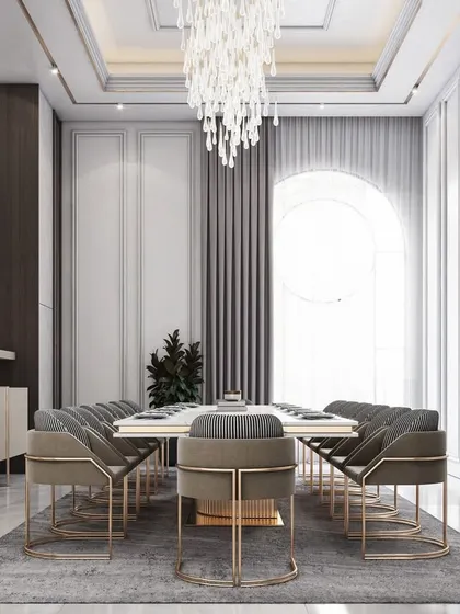 This angle of the dining room shows the large arched window and simple, elegant curtains that create a bright and airy atmosphere.