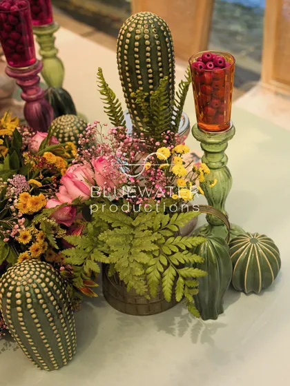 A close-up of a floral arrangement featuring cacti and other unique botanicals, reflecting a personalized and non-traditional approach.