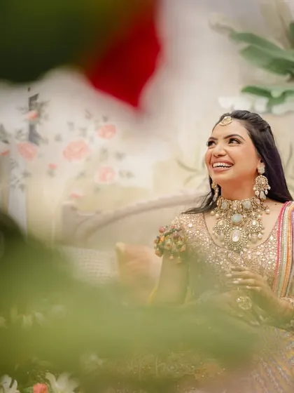 A beautiful, happy portrait of Nikita during her Dastoor. The rosy makeup and polki set with turquoise stones perfectly complement her vibrant outfit.