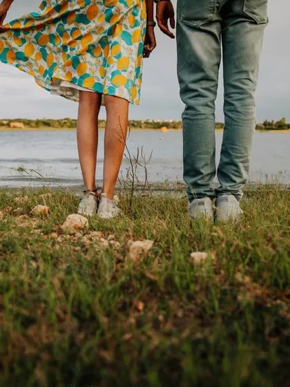 A simple, beautiful shot of a couple's feet by the water. This detail shot tells a story of a relaxed, romantic day together.