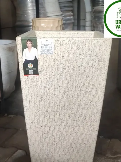 A tall, white, textured fiber pot.