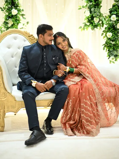 A romantic moment on the reception stage. The bride's makeup is designed to look flawless both up close and from a distance.