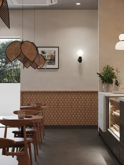 This image shows the transition from the main seating area to the service counter. We used textured wooden paneling and a variety of pendant lights to create visual interest and guide customers through the space.