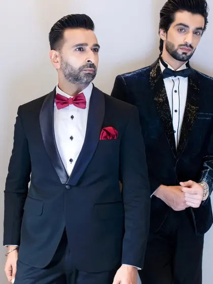 Our legacy of tailoring, passed from one generation to the next. Our founder and head designer are seen here in two of our signature tuxedos, representing the fusion of timeless tradition and modern innovation.