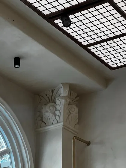 A detail of the ornate, restored column capital inside the Eka store. We chose to preserve and highlight the original architectural features of the heritage building, integrating them into the contemporary retail design.