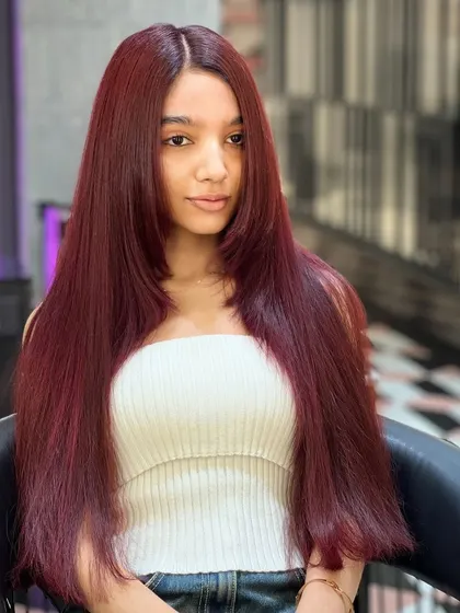 Turning heads with every red strand. This vibrant red is sleek, shiny, and absolutely stunning.